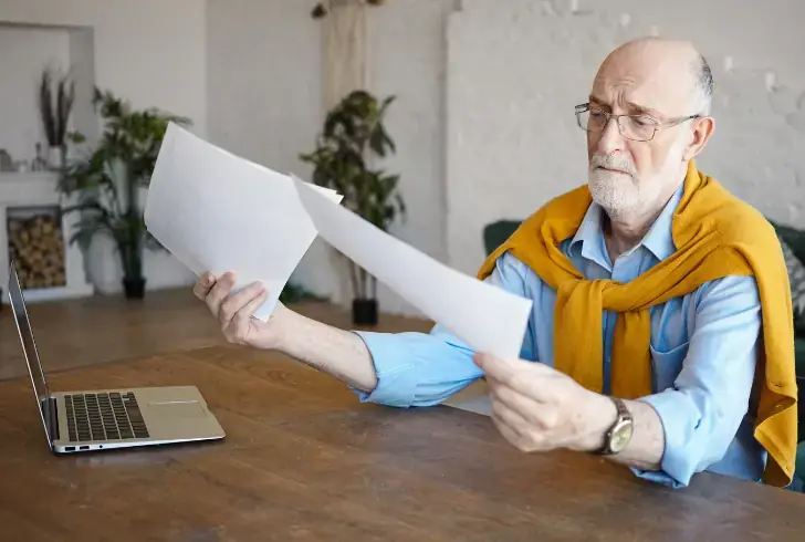 Senior comparing medicare plan details